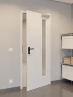 CloseUp-Flur-Milieuansicht von GARANT Rauchschutztür U12188SD Lichtgrau GHK08 mit Lichtausschnitt LA-4 bandseitig